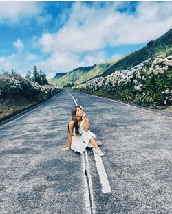 Full length of woman on road against sky