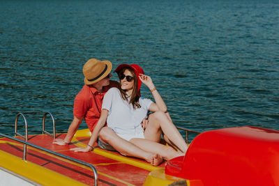 Couple sitting in boat on sea