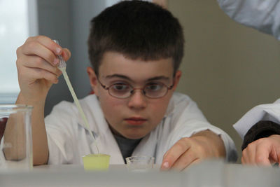 Close-up of boy working in science lab