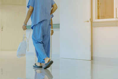 Low section of person walking in corridor of building