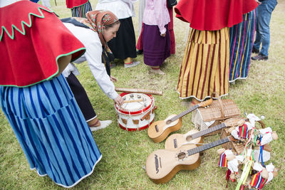 Low section of women standing on grassland