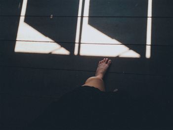 Low section of woman on tiled floor