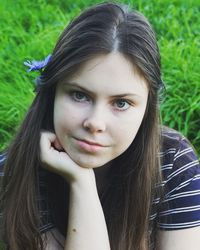 Portrait of beautiful woman on grassy field