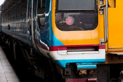 Close-up of yellow train at railroad station