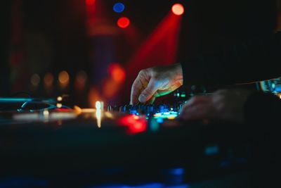 Close-up of hand on illuminated stage