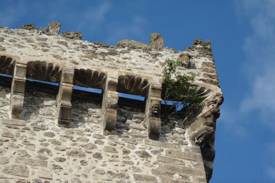 Low angle view of old ruins against blue sky