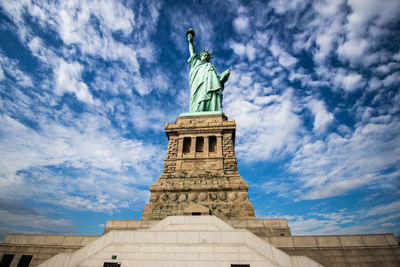 Statue of liberty against cloudy sky