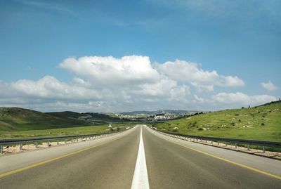 Empty road along countryside landscape