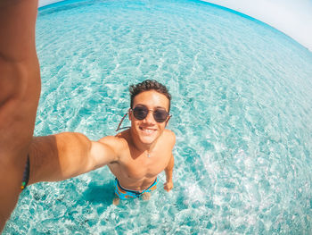 Portrait of smiling young man in swimming pool