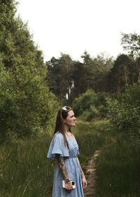 Portrait of woman standing on field