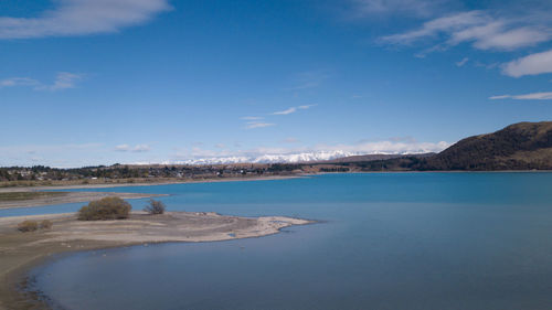Scenic view of sea against blue sky