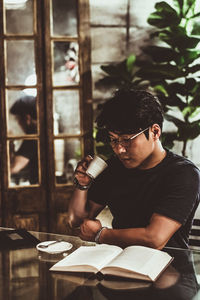 Young man sitting on table