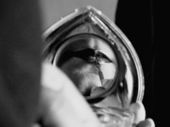 Close-up portrait of young woman holding camera