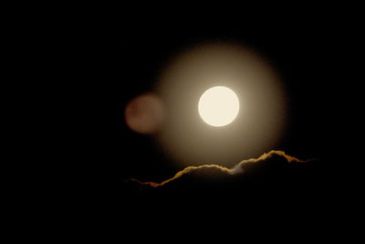 Close-up of illuminated lamp against black background