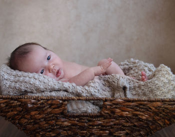 Portrait of cute baby relaxing on bed