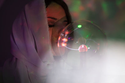 View of woman holding bubbles