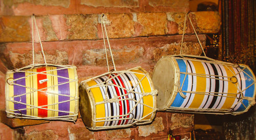 Close-up of drums hanging on wall