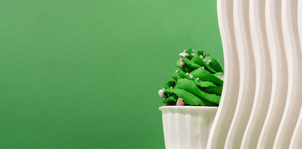 Merry christmas and happy new year. composition of green christmas tree shaped cupcakes