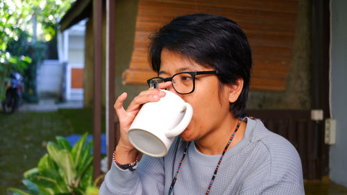 Young woman drinking coffee at home