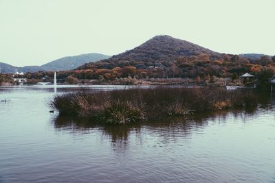 Scenic view of lake and mountains against clear sky