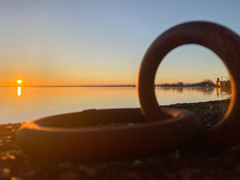 Scenic view of lake against clear sky during sunset