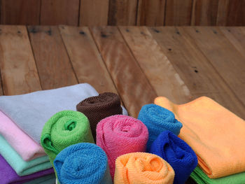 High angle view of colorful towels on wooden floor