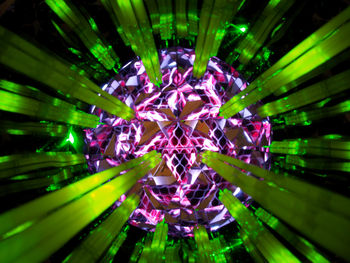 Full frame shot of illuminated lighting equipment against black background