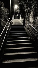 Staircase on illuminated city at night