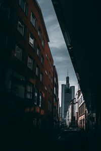 Buildings in city against sky at dusk