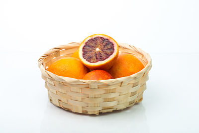 Close-up of orange fruit against white background