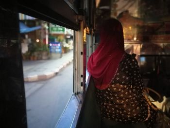 Rear view of woman in bus