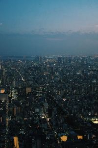 Aerial view of illuminated buildings in city at dusk