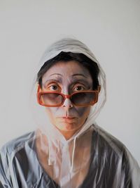 Portrait of mid adult woman against white background