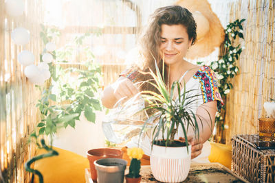 Portrait of smiling young woman holding bouquet