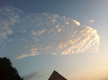 Low angle view of building against cloudy sky