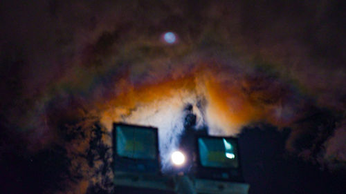 Low angle view of illuminated lights on street at night