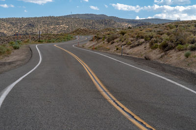 Road passing through landscape against sky