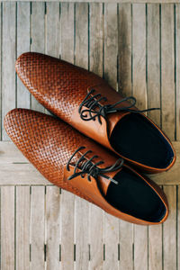 High angle view of shoes on wooden table