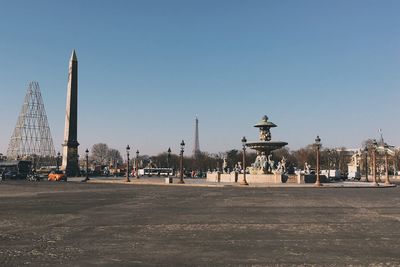 Empty road in city against clear sky