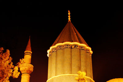 Low angle view of illuminated building against sky at night