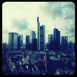 Skyscrapers against cloudy sky