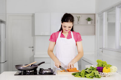 Woman preparing food in kitchen