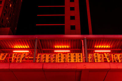 Low angle view of illuminated text on wall at night