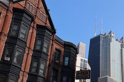 Low angle view of buildings against blue sky