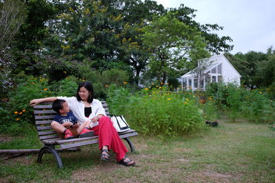 Couple sitting on bench in park