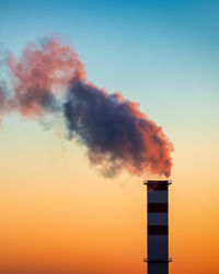 Low angle view of lighthouse against sky during sunset