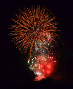 Low angle view of firework display at night