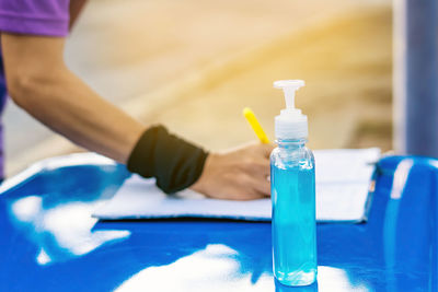 Close-up of hand holding bottle