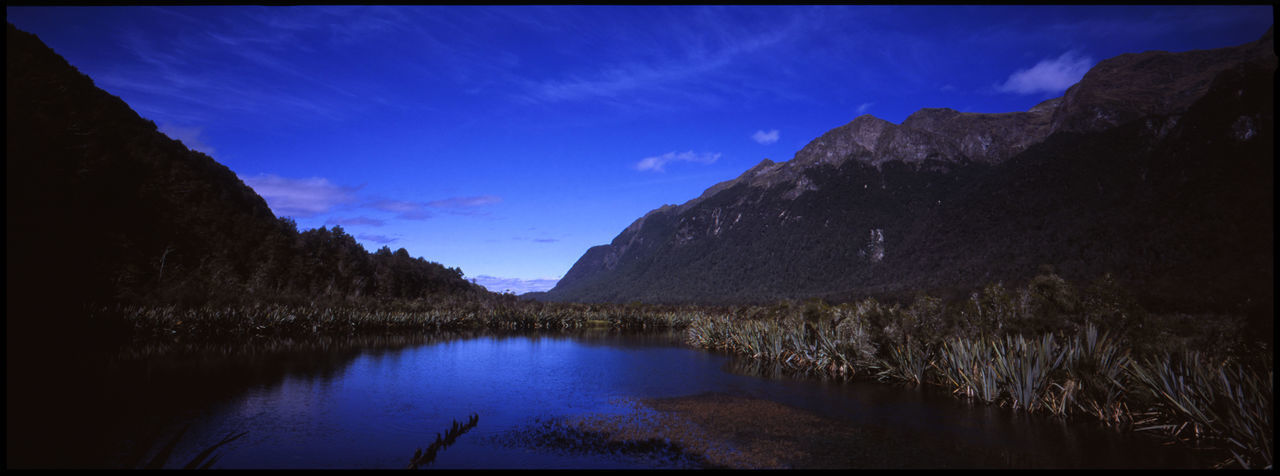 SCENIC VIEW OF LAKE AGAINST BLUE SKY