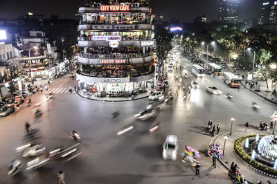 Blurred motion of people and vehicles on street in city